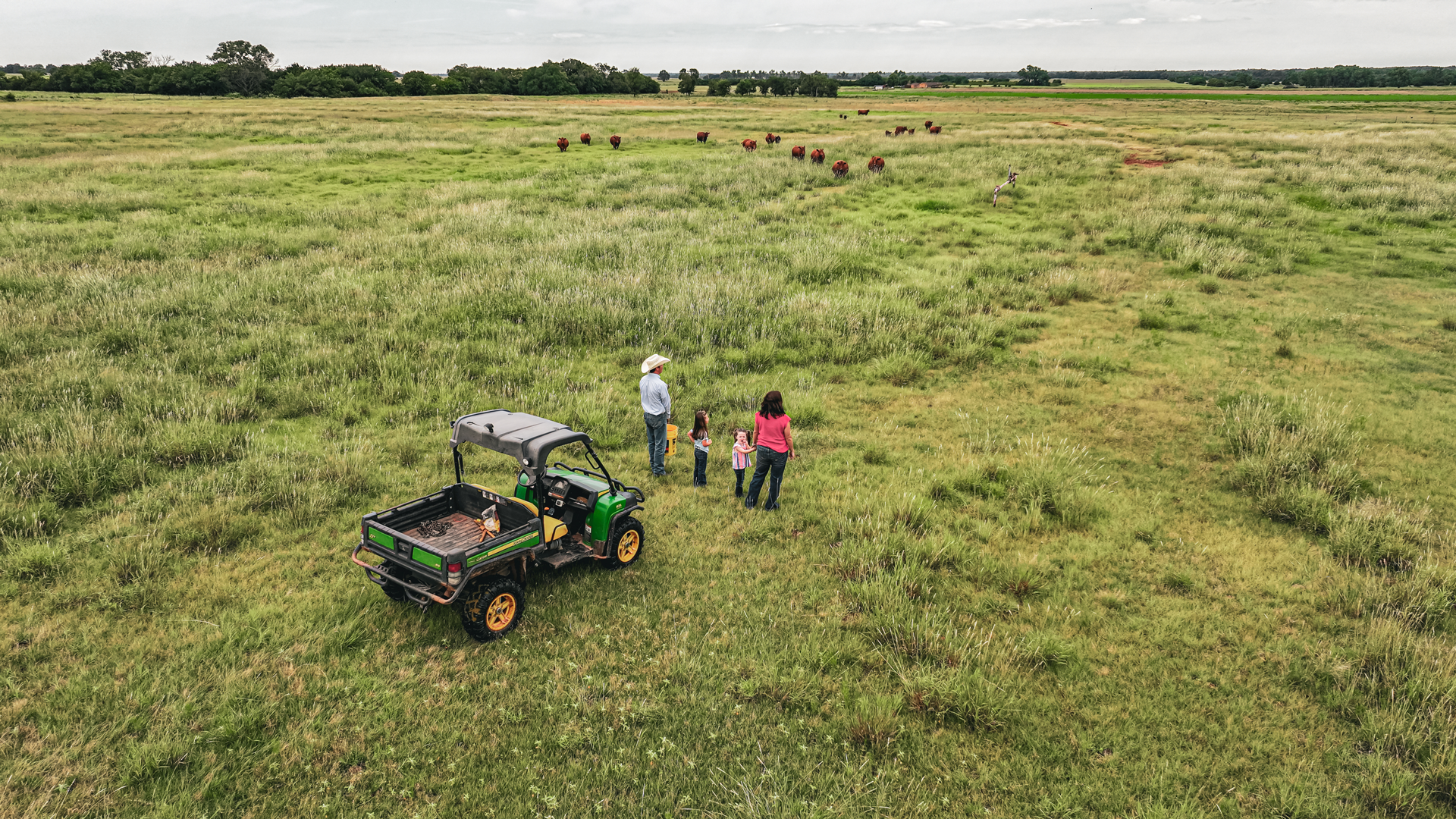Husband, wife, and two daughters in pasture