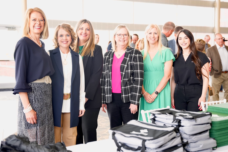 women smiling for a photo at fcwo event